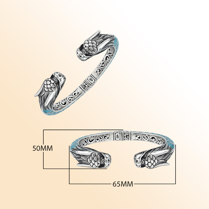 Handcrafted sterling silver phoenix guardian bangle featuring Turquoise Shell accents, rich Balinese scroll engravings, and a secure hinge lock for expressive, meaningful, and beautifully detailed wear.