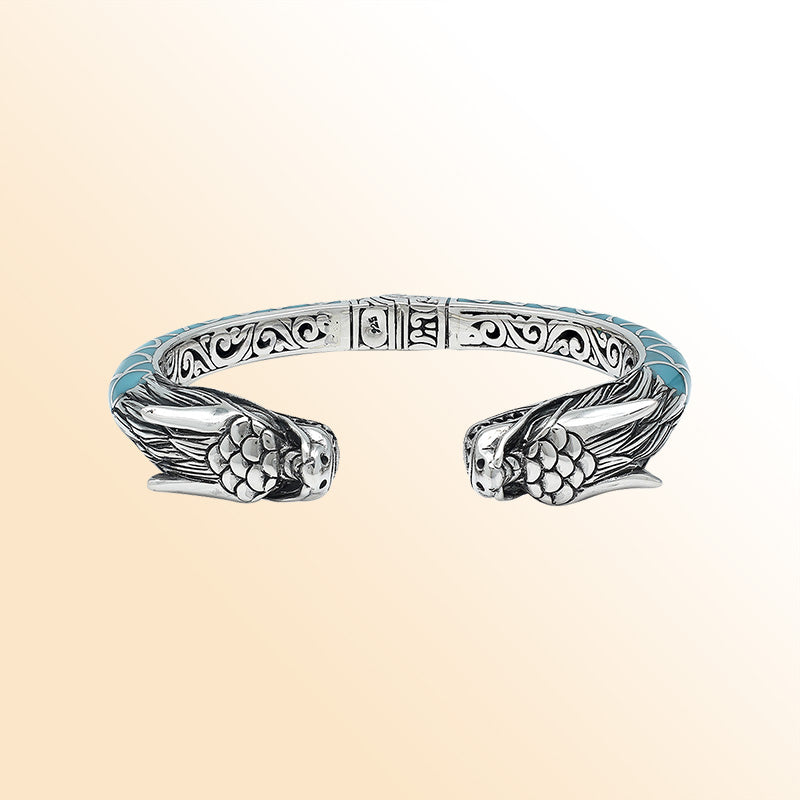 Handcrafted sterling silver phoenix guardian bangle featuring Turquoise Shell accents, rich Balinese scroll engravings, and a secure hinge lock for expressive, meaningful, and beautifully detailed wear.