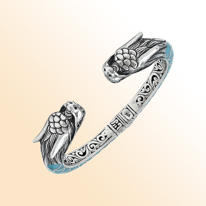 Handcrafted sterling silver phoenix guardian bangle featuring Turquoise Shell accents, rich Balinese scroll engravings, and a secure hinge lock for expressive, meaningful, and beautifully detailed wear.