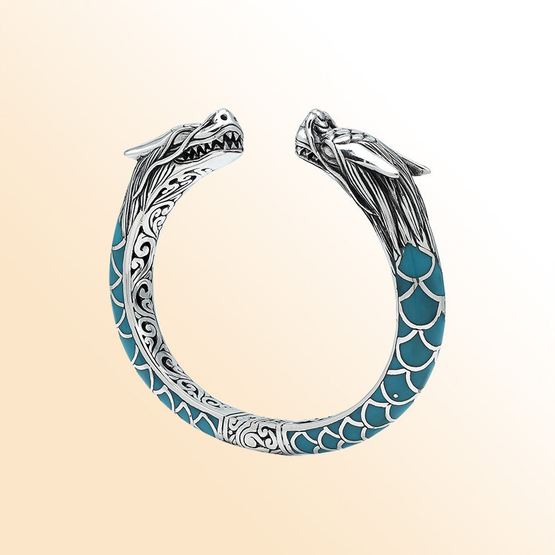 Handcrafted sterling silver phoenix guardian bangle featuring Turquoise Shell accents, rich Balinese scroll engravings, and a secure hinge lock for expressive, meaningful, and beautifully detailed wear.