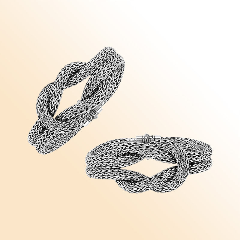 Handcrafted sterling silver woven knot bangle featuring a multi-strand Balinese chain weave design with a secure push clasp, offering symbolic beauty and bold artisan craftsmanship.