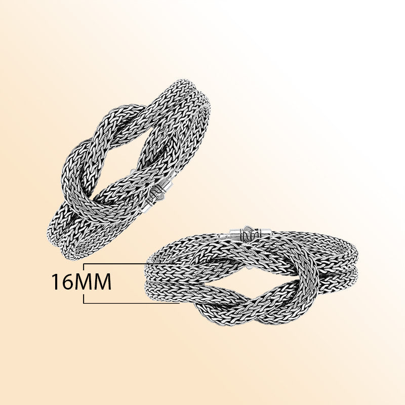 Handcrafted sterling silver woven knot bangle featuring a multi-strand Balinese chain weave design with a secure push clasp, offering symbolic beauty and bold artisan craftsmanship.