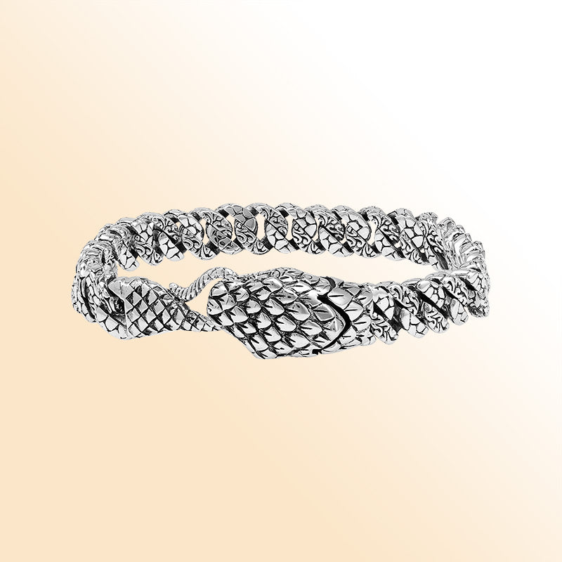 Handcrafted sterling silver dragon-scale bangle featuring a woven chain design, detailed Balinese artistry, and a secure hook lock for bold everyday styling.