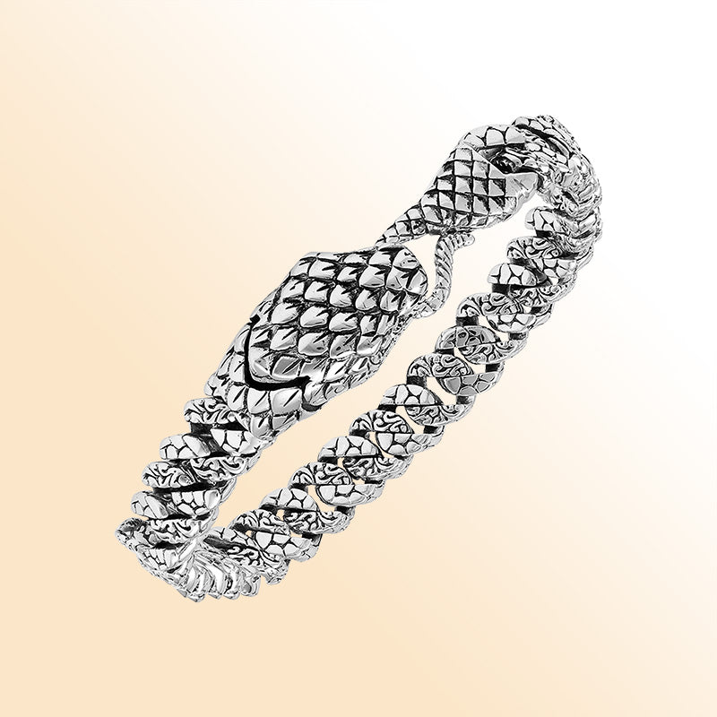 Handcrafted sterling silver dragon-scale bangle featuring a woven chain design, detailed Balinese artistry, and a secure hook lock for bold everyday styling.