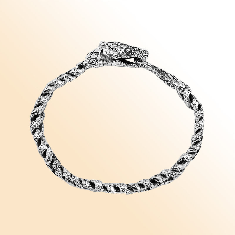 Handcrafted sterling silver dragon-scale bangle featuring a woven chain design, detailed Balinese artistry, and a secure hook lock for bold everyday styling.