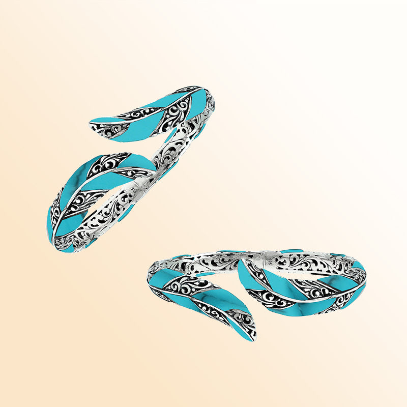 Handcrafted sterling silver feather-inspired bangle featuring vibrant Turquoise Shell inlays, intricate Balinese scroll engravings, and a secure hinge lock for colorful, expressive artisan wear.