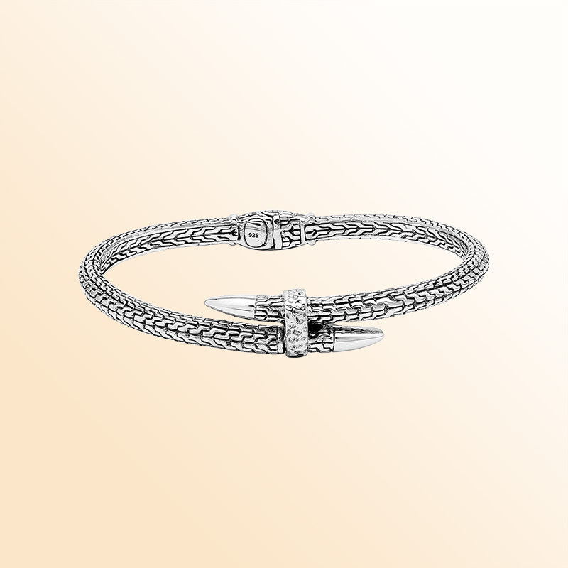 Handcrafted sterling silver woven chain bangle featuring a nail-head design, ornate Balinese scroll engravings, and a secure hinge lock for bold, artisan-inspired daily wear.