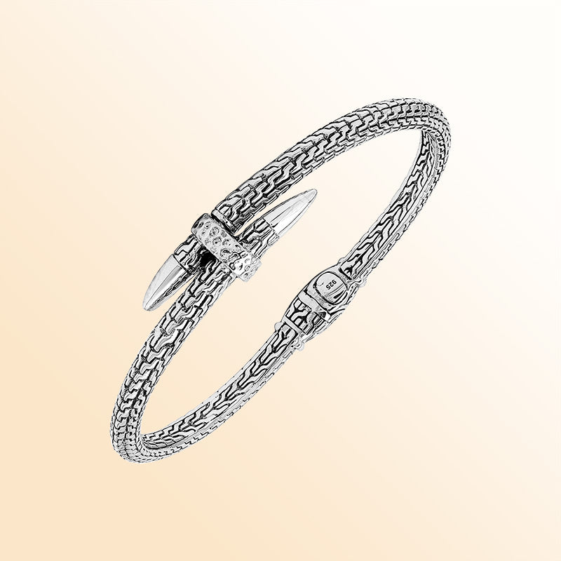 Handcrafted sterling silver woven chain bangle featuring a nail-head design, ornate Balinese scroll engravings, and a secure hinge lock for bold, artisan-inspired daily wear.