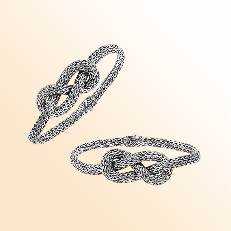 Handcrafted sterling silver bracelet featuring an elegant woven knot centerpiece, detailed chain texture, and a secure push clasp for stylish everyday or special-occasion wear.