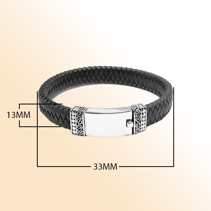 Handcrafted sterling silver and braided leather men’s bracelet featuring a polished central plate and a secure push clasp for refined everyday wear.