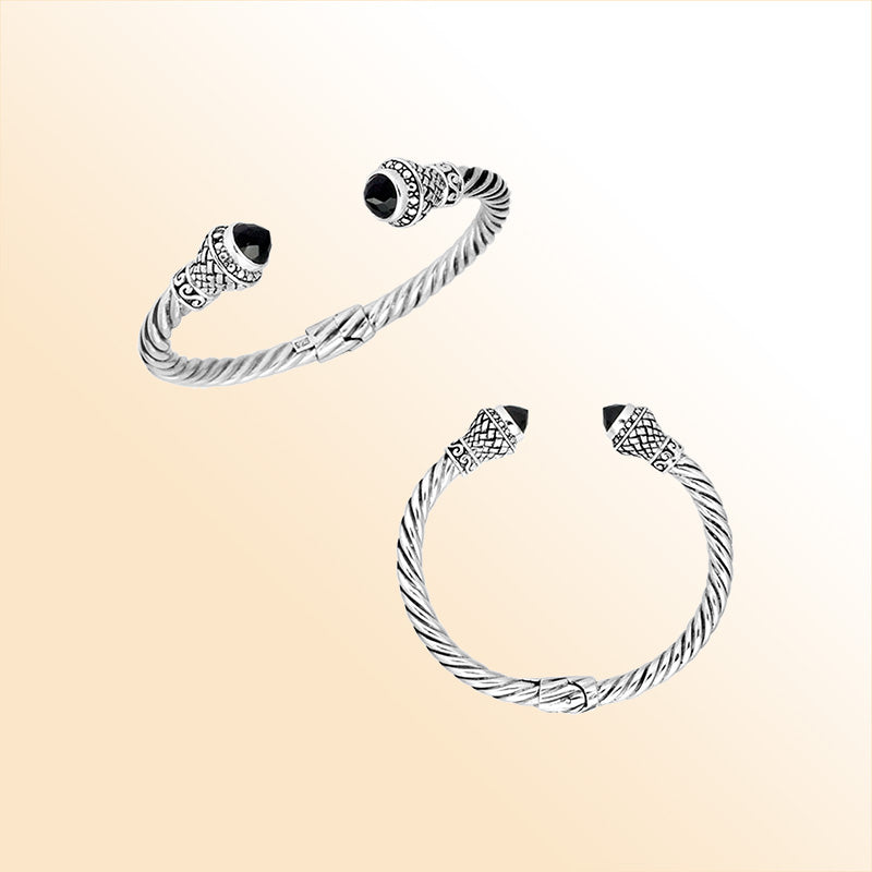 Handcrafted sterling silver twisted cuff bracelet with Black Onyx ends and oxidized Balinese detailing.