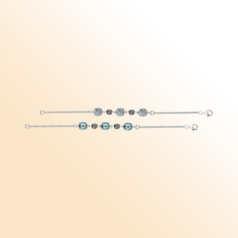 Sterling silver bracelet featuring blue topaz quartz stones and Bali filigree accents in an alternating pattern.