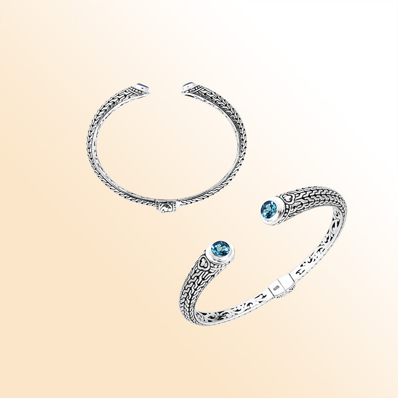 Sterling silver Bali engraved hinge cuff bracelet featuring vibrant blue topaz quartz stones and polished–oxidized detailing, designed for women who enjoy elegant artisan-crafted jewelry.