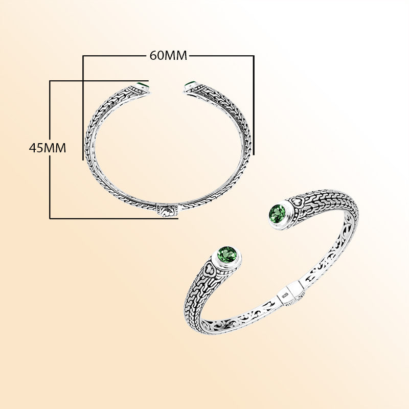 Sterling silver Bali engraved hinge cuff bracelet featuring bright green quartz stones with polished–oxidized detailing, created for individuals who appreciate expressive artisan-crafted jewelry.