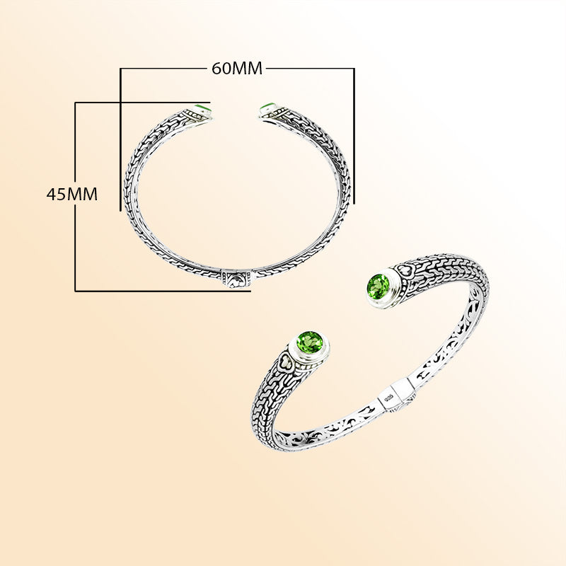 Sterling silver Bali engraved hinge cuff featuring radiant peridot quartz stones and polished–oxidized detailing, designed for individuals who appreciate expressive artisan-crafted jewelry with vibrant color.