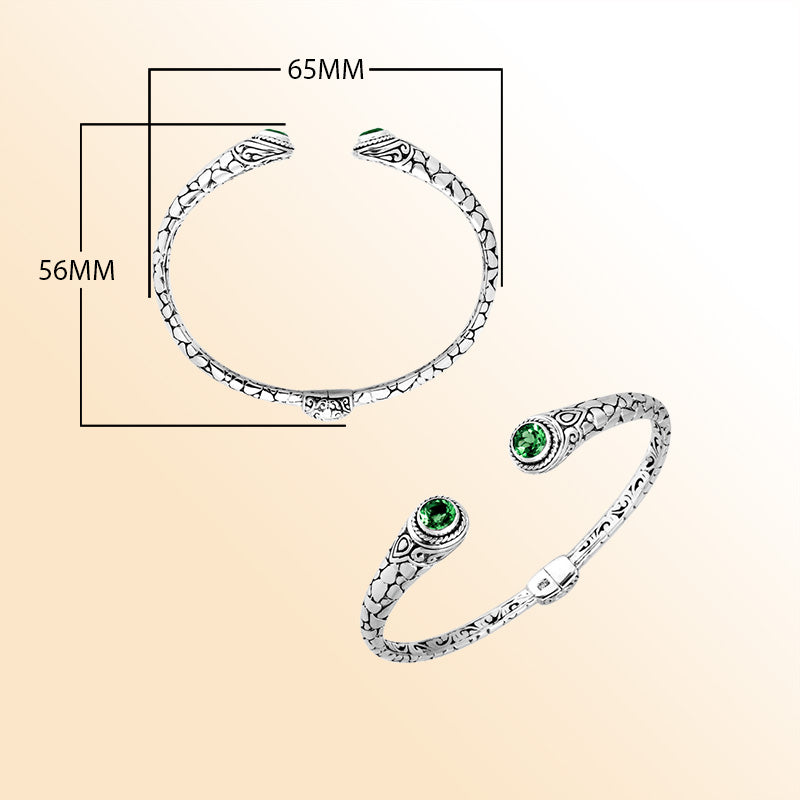 Sterling silver Bali hinge cuff bracelet featuring luminous green quartz ends and polished–oxidized engravings, crafted for individuals who enjoy expressive, artistic, and finely detailed jewelry pieces.