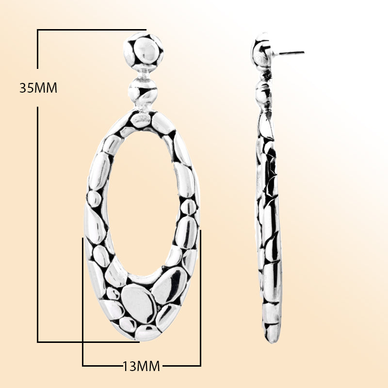 "Sterling silver hammered oval drop earrings with pebble-textured design, handcrafted Bali jewelry for everyday wear and special occasions."