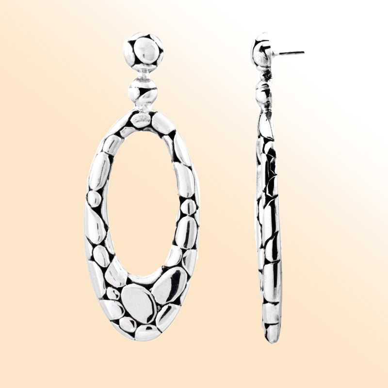 "Sterling silver hammered oval drop earrings with pebble-textured design, handcrafted Bali jewelry for everyday wear and special occasions."