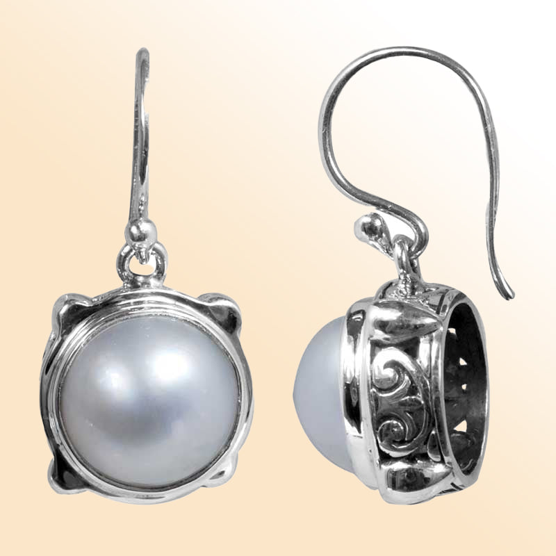 Sterling silver earrings with round white pearl in Bali-inspired design for retail customers.