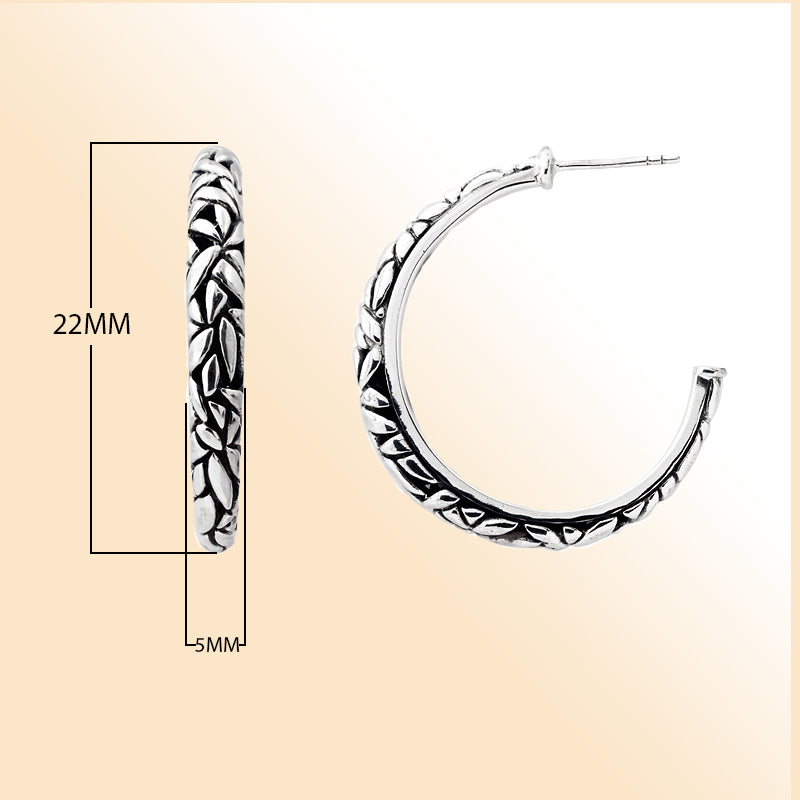 Handcrafted sterling silver hoop earrings with textured leaf design and oxidized finish, artisan Bali jewelry