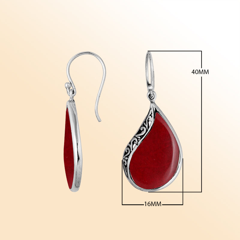 Handcrafted sterling silver teardrop drop earrings with bold red coral inlay and Balinese scrollwork design