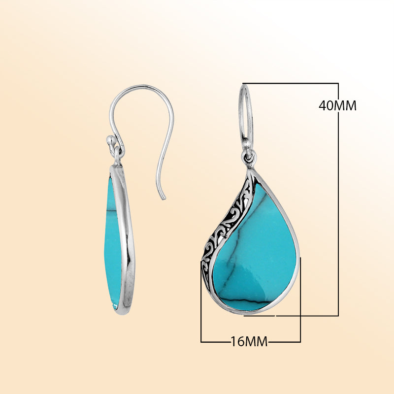 Handcrafted sterling silver teardrop drop earrings with vibrant turquoise inlay and Balinese scrollwork design