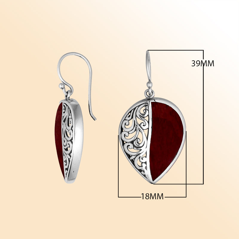 Teardrop silver earrings featuring vivid Red Coral and ornate Bali scrollwork.