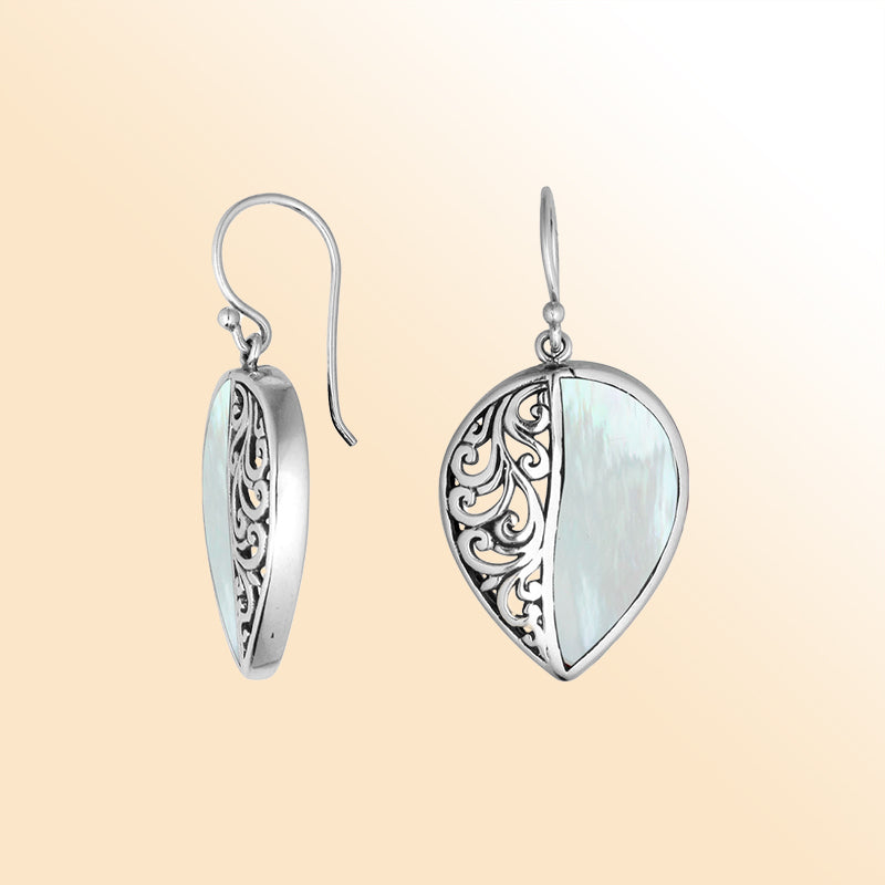 Teardrop silver earrings featuring lustrous Mother of Pearl and ornate Bali scroll pattern.