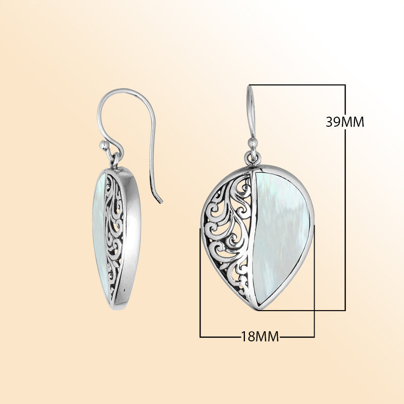 Teardrop silver earrings featuring lustrous Mother of Pearl and ornate Bali scroll pattern.