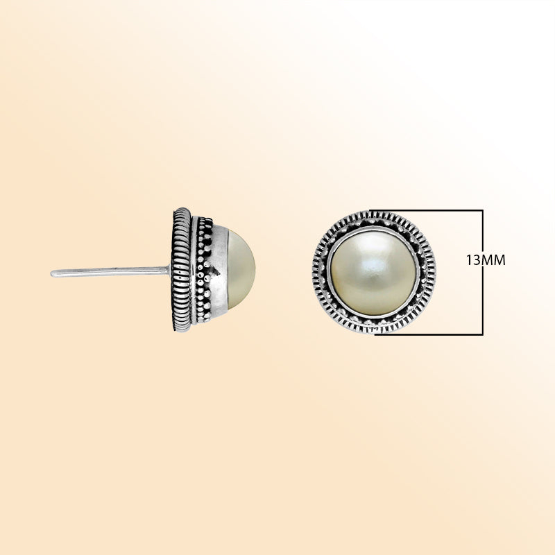 Silver stud earrings featuring White Pearls with ornate dotted Bali detailing.