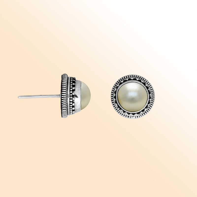Silver stud earrings featuring White Pearls with ornate dotted Bali detailing.