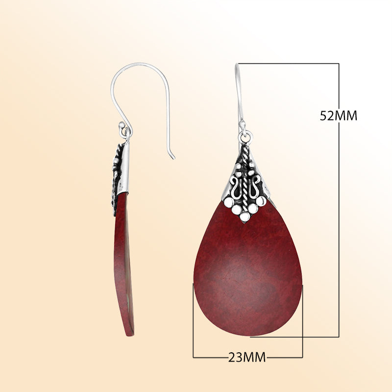 Elegant Red Coral teardrop earrings with ornate silver detailing and earwire lock
