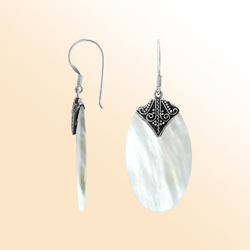 Elegant Mother Of Pearl oval earrings with ornate scroll silver detailing and earwire lock