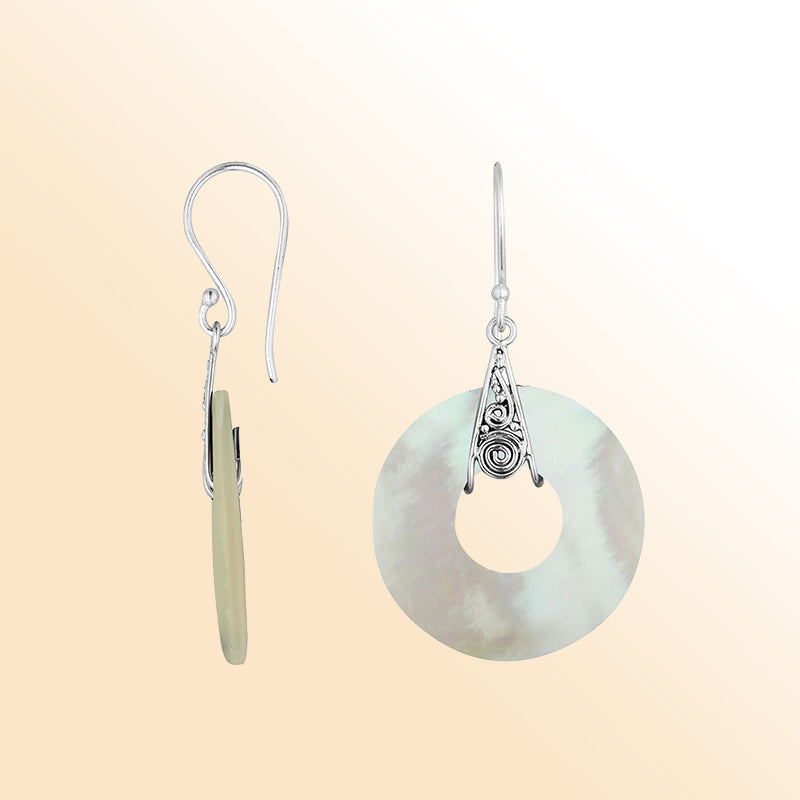 A stunning pair of 925 sterling silver earrings featuring round Mother Of Pearl drops with detailed Balinese filigree work and secure earwire hook design.