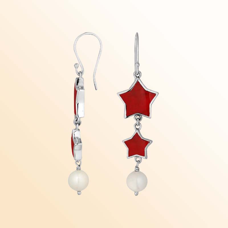 Sterling silver celestial dangle earrings with two graduated red coral stars, luminous round pearl drops, polished silver outlines, delicate connectors, and graceful fishhook ear wires.