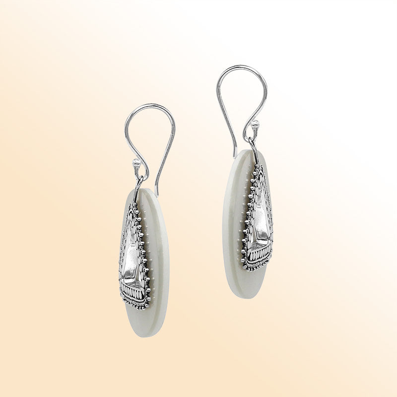Artistic Mother Of Pearl round earrings with silver beaded triangle cut-out.