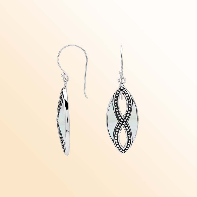 Elegant Sterling Silver Mother Of Pearl drop earrings displaying softly shimmering white shell inlays, intricate infinity-shaped silver openwork, oxidized beaded accents, polished marquise frames, and graceful fishhook ear wires.