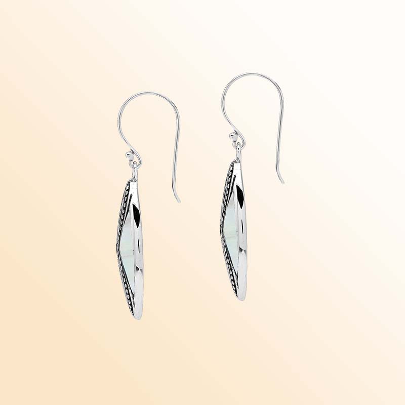 Elegant Sterling Silver Mother Of Pearl drop earrings displaying softly shimmering white shell inlays, intricate infinity-shaped silver openwork, oxidized beaded accents, polished marquise frames, and graceful fishhook ear wires.
