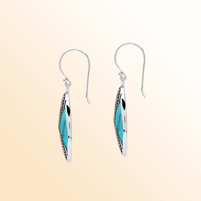 Elegant Sterling Silver Turquoise Shell drop earrings showcasing vivid tropical blue inlays, intricate infinity-shaped silver openwork, delicate oxidized beaded accents, polished marquise frames, and graceful fishhook ear wires.