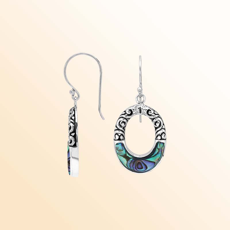 Handcrafted sterling silver dangle earrings with vibrant Abalone Shell inlay, elegant oval openings, sculpted scrollwork, rich oxidized accents, and graceful French ear wires.