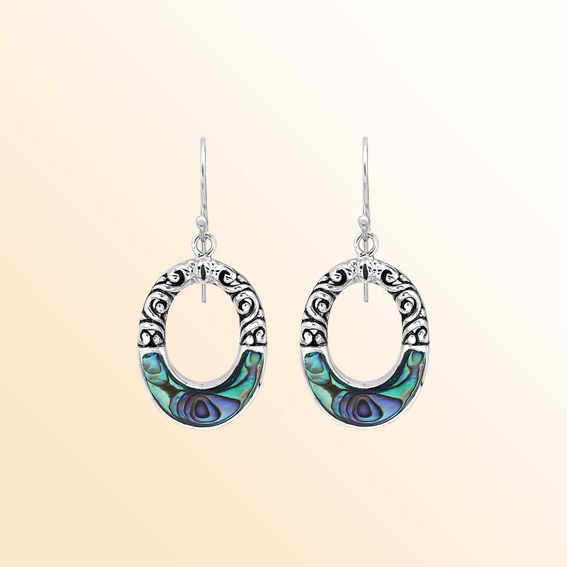 Handcrafted sterling silver dangle earrings with vibrant Abalone Shell inlay, elegant oval openings, sculpted scrollwork, rich oxidized accents, and graceful French ear wires.