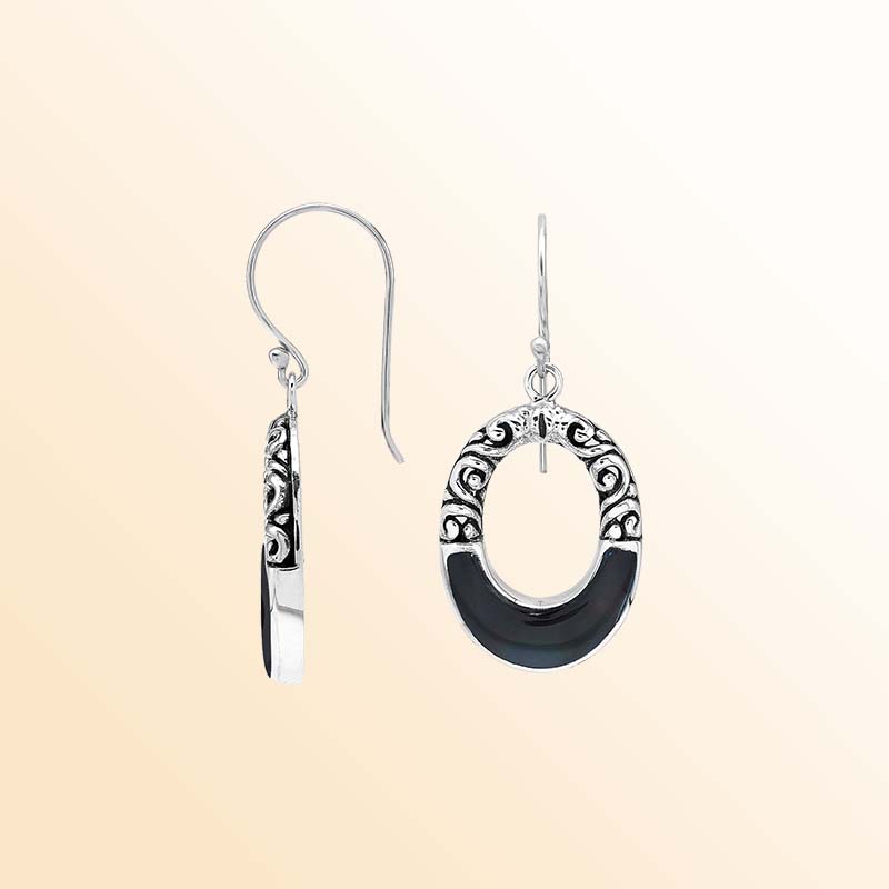 Handcrafted sterling silver dangle earrings showcasing glossy Black Shell inlays, graceful oval openings, ornamental scrollwork, contrasting oxidized accents, polished edges, and elegant French ear wires.
