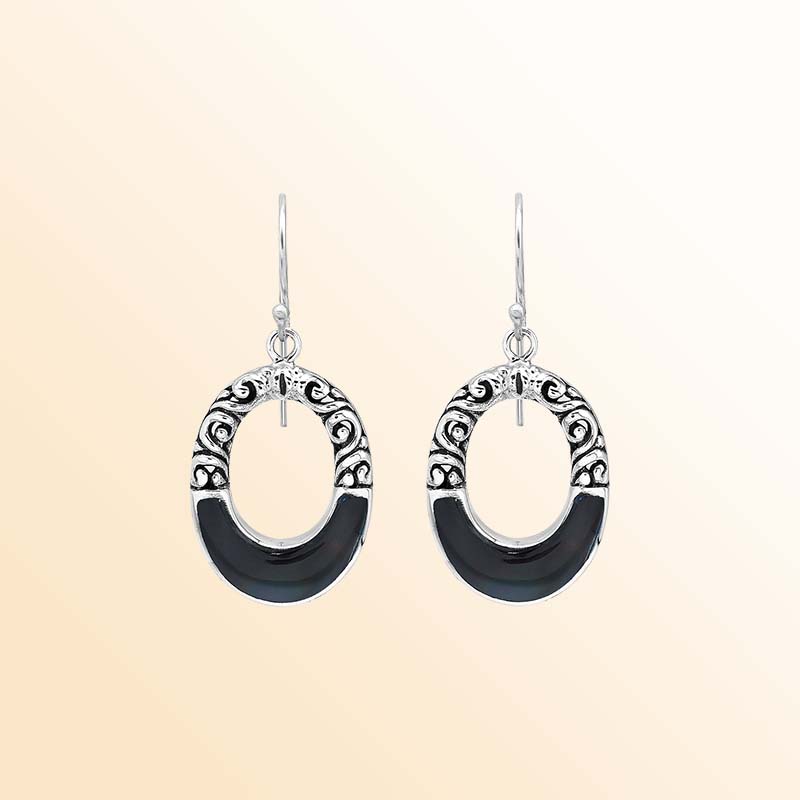 Handcrafted sterling silver dangle earrings showcasing glossy Black Shell inlays, graceful oval openings, ornamental scrollwork, contrasting oxidized accents, polished edges, and elegant French ear wires.
