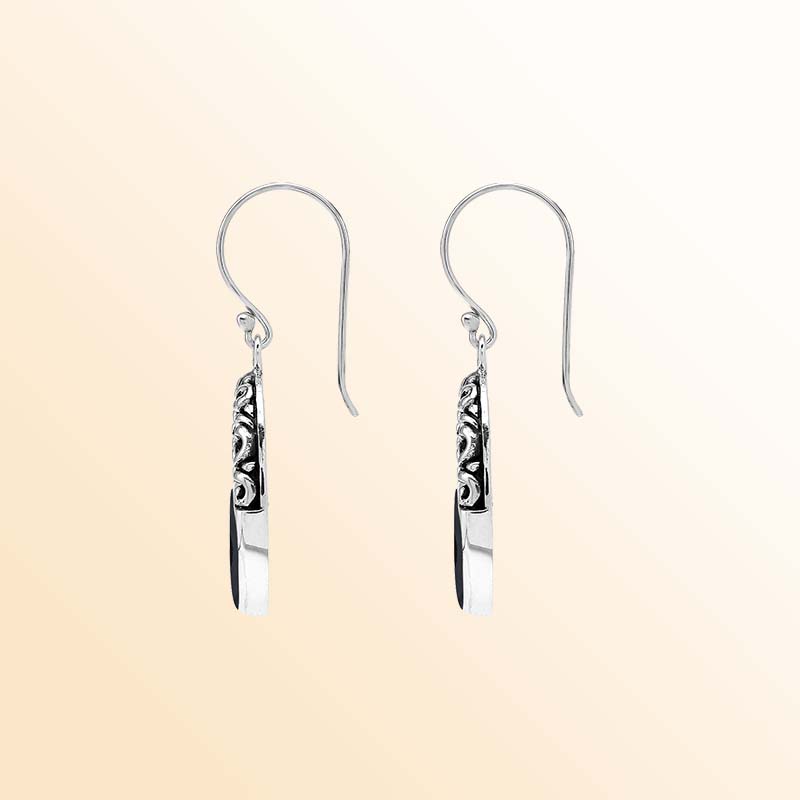 Handcrafted sterling silver dangle earrings showcasing glossy Black Shell inlays, graceful oval openings, ornamental scrollwork, contrasting oxidized accents, polished edges, and elegant French ear wires.