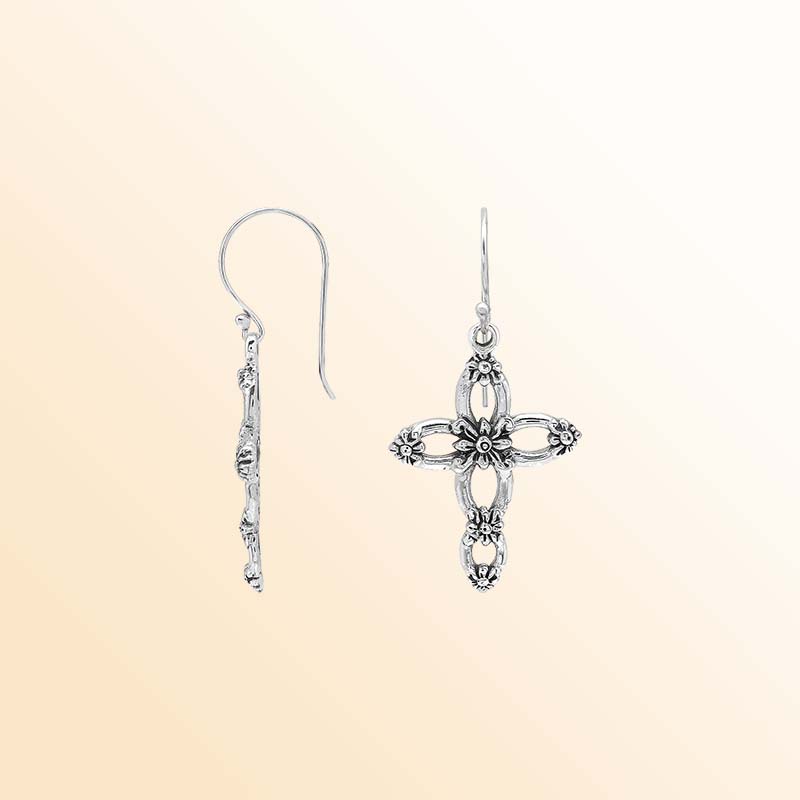 Handcrafted sterling silver floral cross earrings with delicate sculpted blossoms, airy oval openings, luminous polished highlights, oxidized depth, and graceful French ear wires.