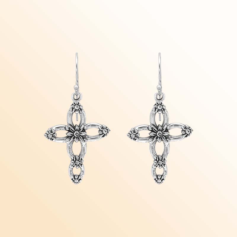 Handcrafted sterling silver floral cross earrings with delicate sculpted blossoms, airy oval openings, luminous polished highlights, oxidized depth, and graceful French ear wires.