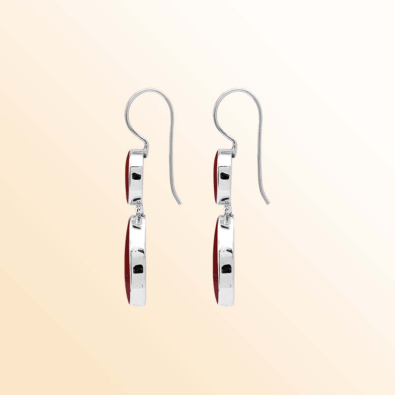 Elegant sterling silver Red Coral earrings featuring rich crimson round and teardrop drops, polished silver bezel frames, articulated movement, and graceful elongated ear wires.