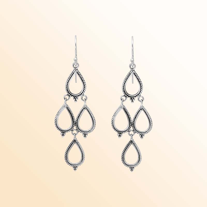Artistic sterling silver chandelier earrings with cascading open teardrop frames, twisted rope detailing, delicate bead accents, elongated ear wires, and graceful articulated movement.