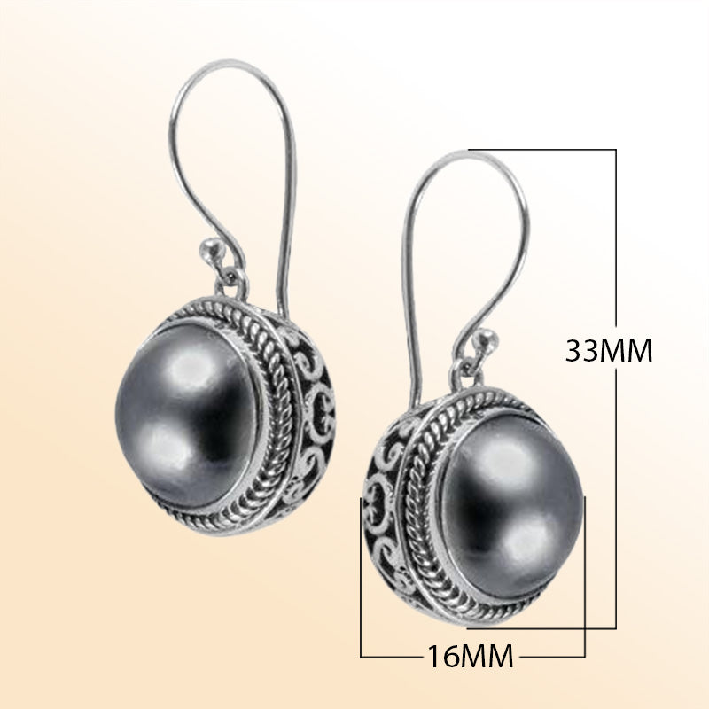 Sterling silver artisan earrings featuring Grey Mabe Pearl in ornate Bali-style detailing with earwire lock.