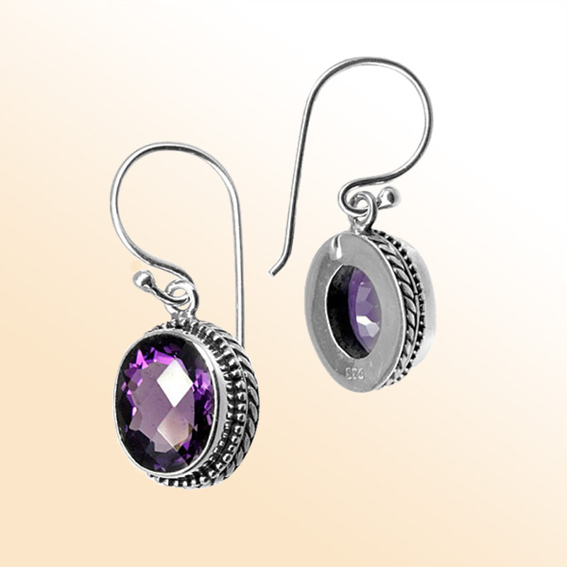 Sterling silver artisan drop earrings featuring Amethyst Quartz with ornate detailing and earwire lock.